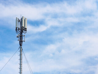 Cellular network antenna against blue sky.