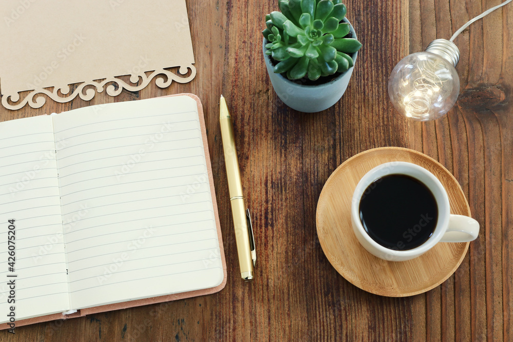 Fototapete top view image of open notebook with blank pages next to cup of coffee on wooden table. ready for ad