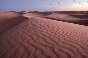 Blue hour on the Sahara Desert sand dune patterns, Erg Chebbi, Merzouga, Morocco, North Africa