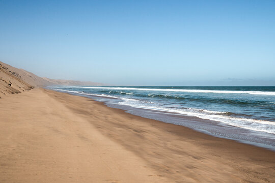 High sand dunes of the Namib Desert meet the ocean, Sandwich Harbour, Namibia