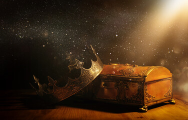 low key image of beautiful queen or king crown over gold treasure chest. vintage filtered. fantasy...