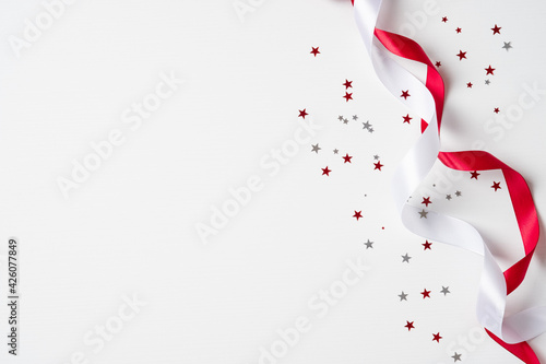 Happy Canada Day banner mockup. Canada flag colors confetti and ribbons on white background. Canadian Independence Day celebration.