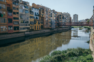A bridge over a body of water with a city in the background