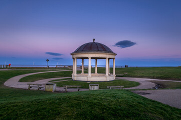 A Blyth bandstand near South Beach before the sunset  occasionally used by music groups or choirs.  North sea in the background.  Blyth, Northumberland, UK.