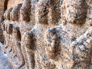 Bas relief ancient sculptures carved on the walls of historical Brihadeeswarar temple in Thanjavur, Tamilnadu. Indian rock art relief carvings of ancient God sculptures in temple walls in Tamilnadu.