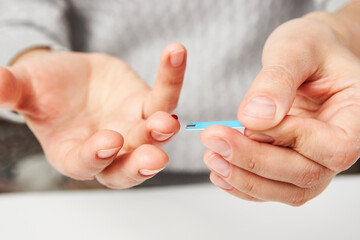 Woman with blood glucose meter, close-up
