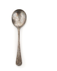 Old distressed spoon on white with copy space.