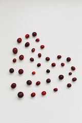 a heart made with fresh cranberries on white background