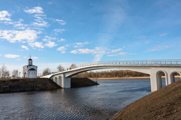 White Orthodox church and bridge on a bright sunny day against a blue sky