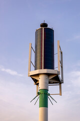 Weather forecast air pressure wind data collection mast station against a blue sky with clouds at sunset