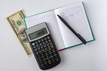 calculator, money, notepad and pen on a white background. Planning and accounting. Home Finance