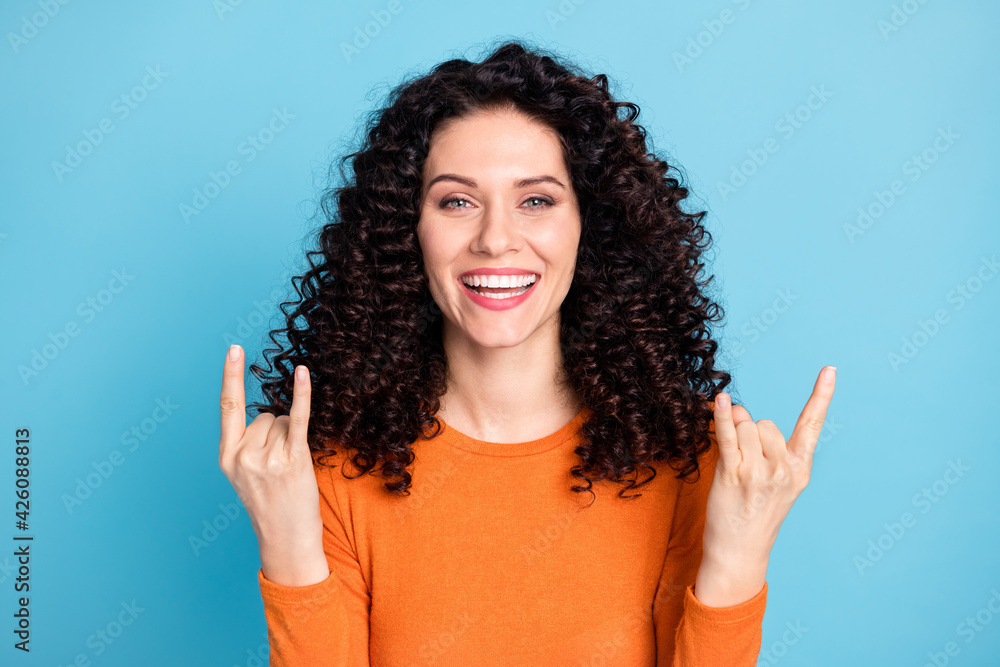 Sticker Portrait of attractive brunet cheerful cool girl showing double horn sign having fun isolated over bright blue color background