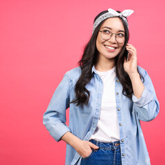 Positive young Asian girl speaks by mobile phone.