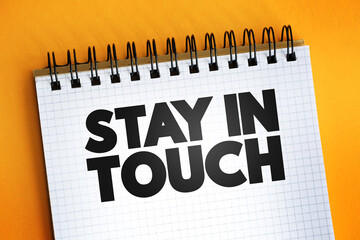 Stay In Touch text quote on notepad, concept background
