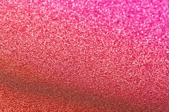 Bright rich red with pink shiny background with blur. Sparkling foil sequins. Abstract stock texture