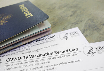US passport with COVID-19 Vaccination Record Cards, issued by the United States CDC to indicate an individial has been vaccinated against the Coronavirus