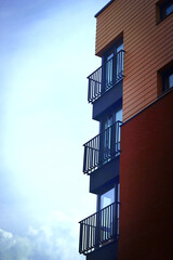 Modern building corner on blue sky with clouds