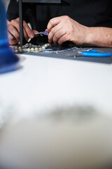 Professional jeweler crafting a purple agate pendant