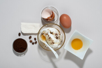 Egg White Face Mask ingredients. Whipped egg white, honey, coffee grounds. Top view.