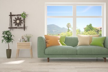 White living room with sofa and summer landscape in window. Scandinavian interior design. 3D illustration