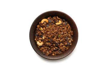 Chocolate granola cereal with nuts in a bowl background.
