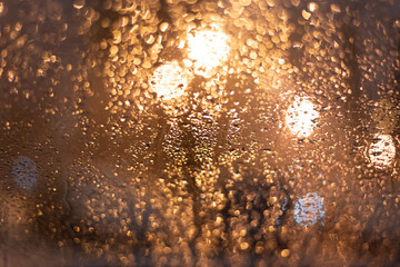 Blurred background with raindrops and lights.