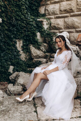 Fototapeta na wymiar Portrait of the bride in a white dress. Photoshoot in the garden.