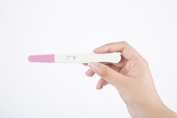 Isolated shot of a hand holding a negative pregnancy test kit on a white background - obrazy, fototapety, plakaty