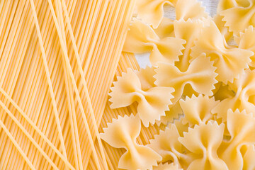 Dry raw pasta and spaghetti on the white background