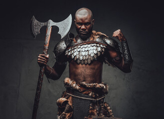 Evil barbaric man with black skin and axe in dark background