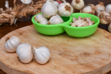 Garlic Cloves and Bulb on wooden cutting board. Garlic on wooden table background