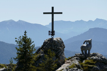 Cross and capricorn at Brauneck mountain tour in Bavaria, Germany