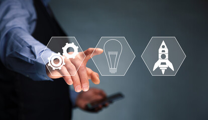 man holding phone with start up icon