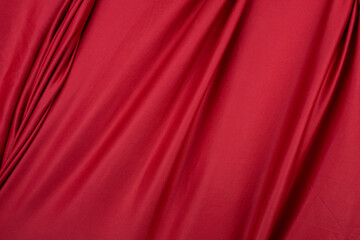 Texture, background, template. Silk fabric. Red silk drapery and upholstery fabric. Solid fabrics for backdrop, drapes, flags and curtains