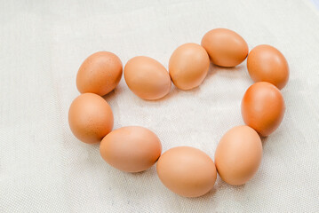 Chicken Egg with heart shape on sack background