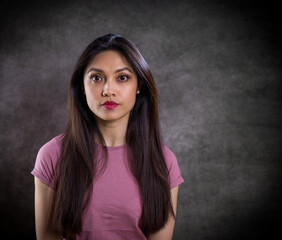 Pretty Asian woman - portrait shot against grey background - studio photography