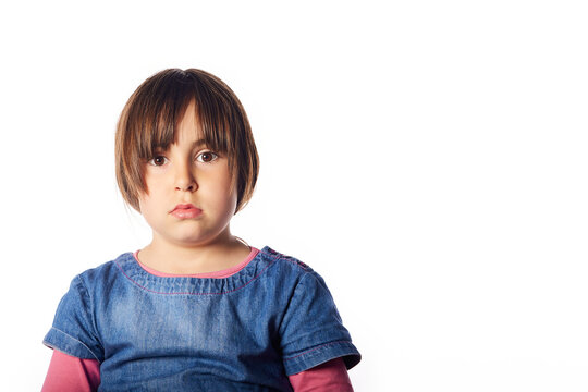 Hispanic Girl Of 5 Years Looking At Camera With An Surprise Gesture. White Background And Large Copyspace For Marketing And Advertising.