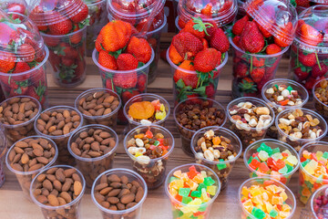 Various nuts and strawberries for sale, outdoor market