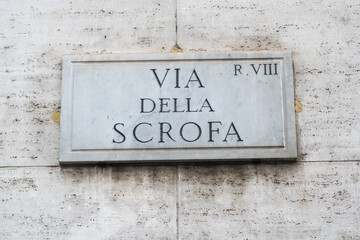 Street sign in Rome, marble plate on street wall with te writing : "Via della Scrofa"