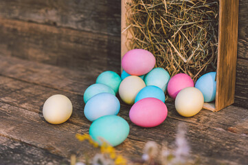 Close-up, a bunch of eggs with hay Against the background of a vintage board.