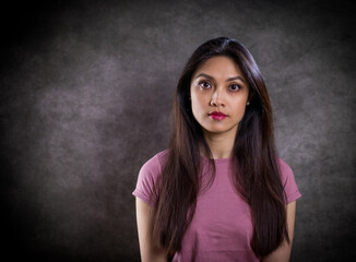 Pretty Asian woman - portrait shot against grey background - studio photography