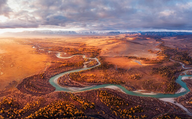sunrise over the autumn steppe with the river against the background of mountains Altai Chuya Kurai