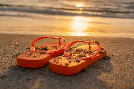 United States, Florida, Boca Raton, Flip flops on beach at sunset