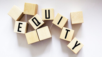 Obraz premium The word EQUITY is composed of building blocks on a white background.