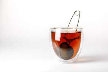 glass with tea with a teapot on a white background