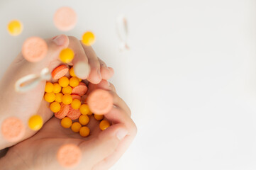 Blurred image of pills falling into the hands of a child.