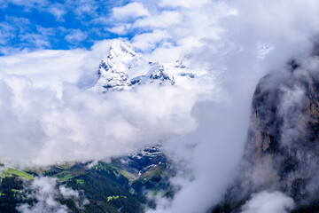 The Swiss Alps at Murren, Switzerland. Jungfrau Region. Tops of the mountains in fog and clouds.