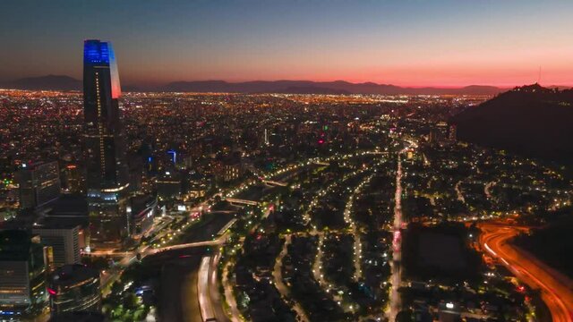 Hyperlapse from a drone over financial district over Santiago de Chile at sunset with cars in the streets