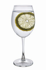 In a glass, transparent goblet, water with air bubbles and a round, yellow slice of lemon. Isolated.