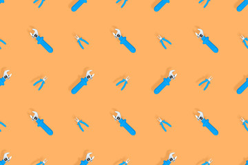 Tools seamless pattern. Background made of tools, pliers and an adjustable wrench.